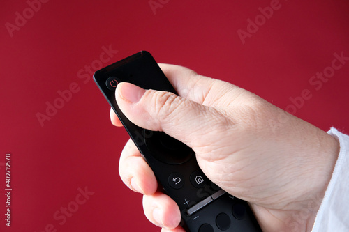 Wallpaper Mural female hand holds remote control, joystick from TV, presses the button of musical apparatus, concept of modern technologies Torontodigital.ca