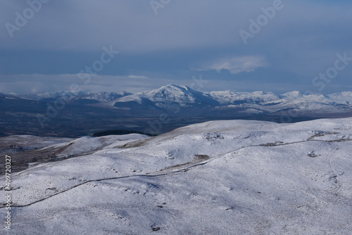 Landscape view if snow covered mountains in Scotland on a bright summer day