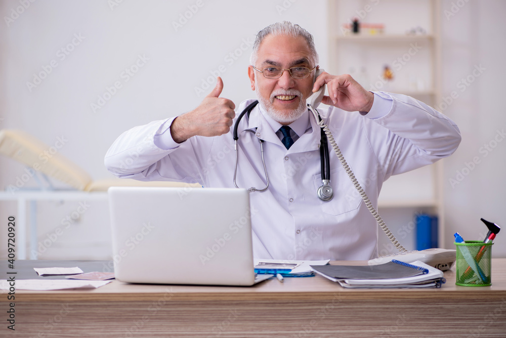 Old male doctor in telemedicine concept Old male doctor in telemedicine concept