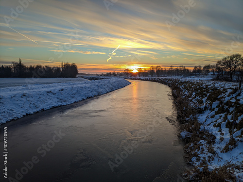 Kanal in Ostfriesland im Winter mit Eis und Schnee  photo