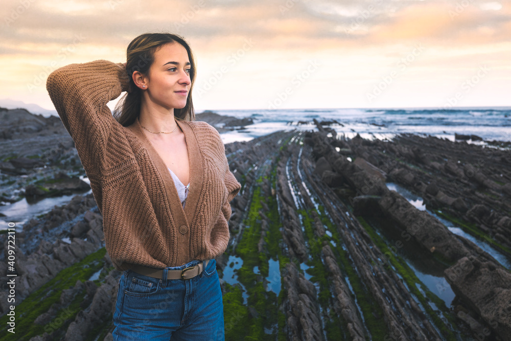 Young caucasian woman at the flysch geopark at the Basque Country ...
