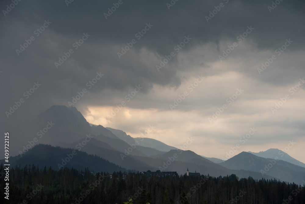 Polish Tatra Mountains under cloudy sky. 