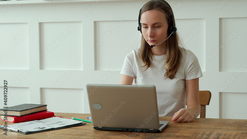 Female operator working with headset and laptop in call center Female operator working with headset and laptop in call center