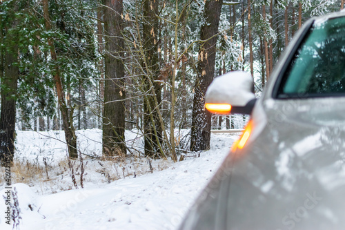 The car broke down in the winter forest. The car got stuck in the winter in the cold.