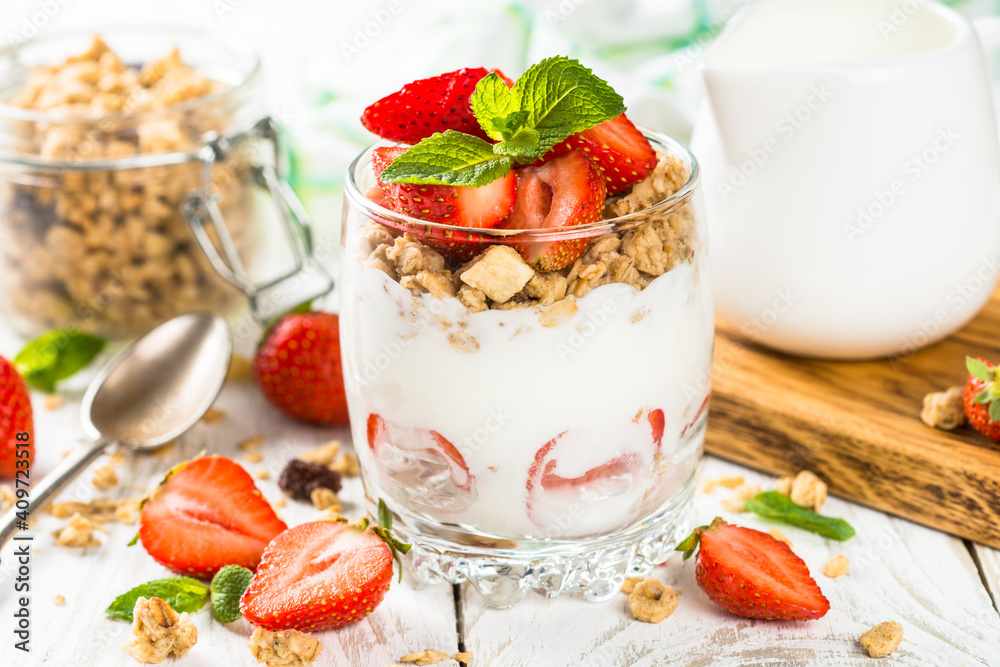 Greek yogurt with fresh strawberry and granola in glass jar. Parfait. Greek yogurt with fresh strawberry and granola in glass jar. Parfait.