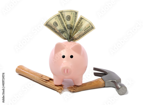strong piggy bank with money and broken hammer cutout on white background photo