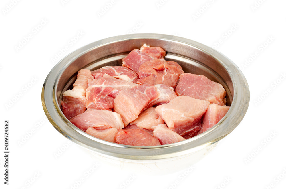 Chunks of fresh raw meat in metal bowl on white background. Studio Photo Chunks of fresh raw meat in metal bowl on white background. Studio Photo