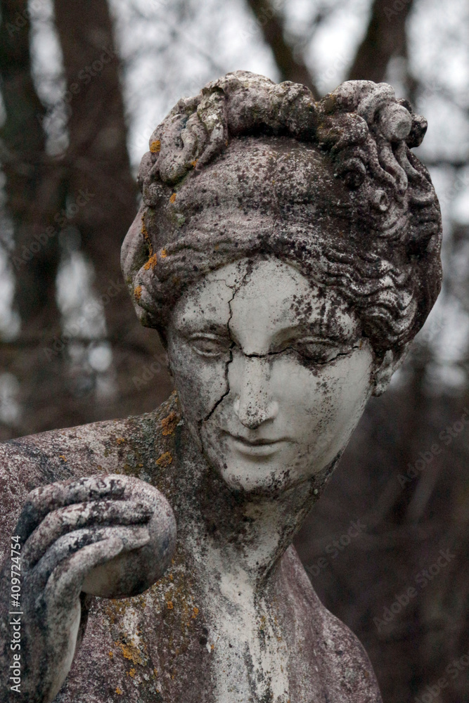 Sculpture of a woman's face through time shows the passage of time and inclement weather..