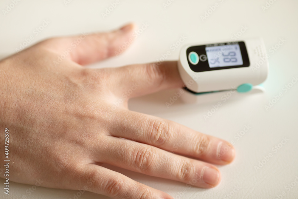 Pulse oximeter on finger showing oxygen saturation and heart rate. Oxymeter. Pulse oximeter on finger showing oxygen saturation and heart rate. Oxymeter.