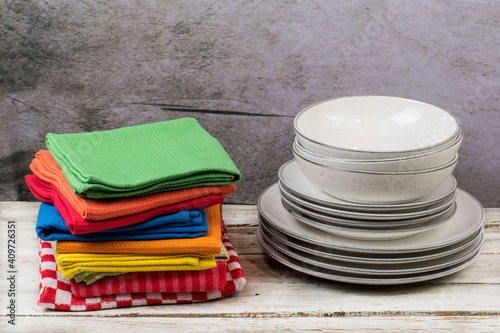 Kitchen towels with dishes on wooden table