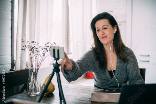 A woman works, conducts live broadcasts from home on the Internet