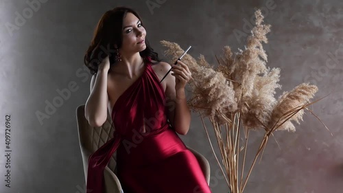 woman in a red dress with a wheat