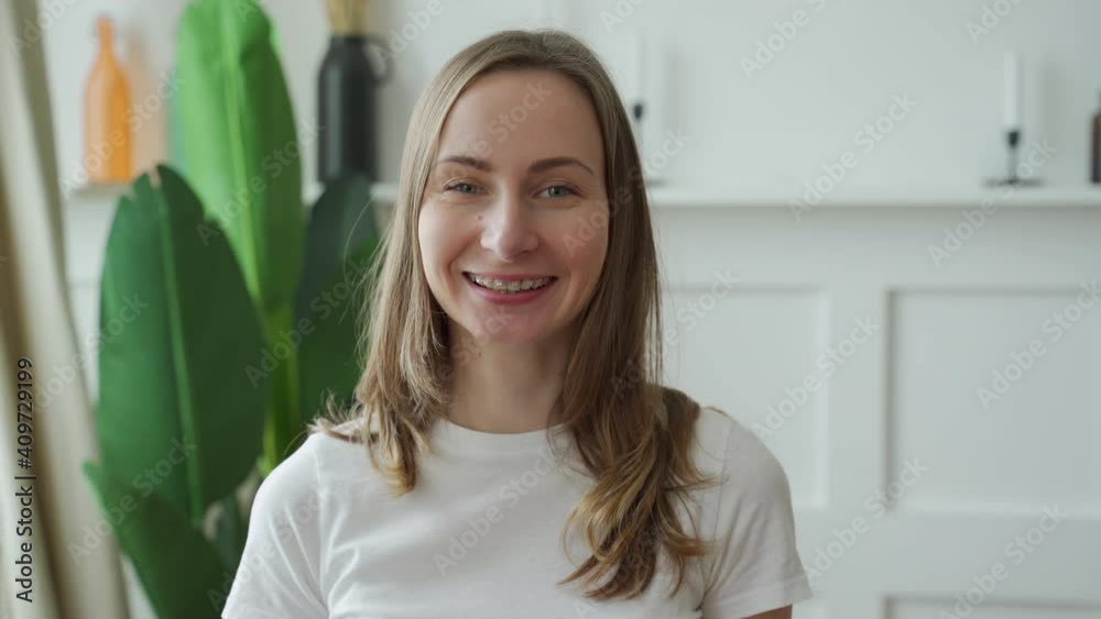 Portrait of a positive emotional woman who smiles while looking at the camera Portrait of a positive emotional woman who smiles while looking at the camera