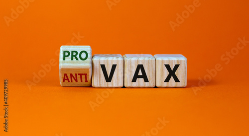 Pro-vax or anti-vax symbol. Turned a cube, changed words 'anti-vax' to 'pro-vax'. Beautiful orange background. Copy space. Business, medical covid-19 pro-vax or anti-vax concept. photo