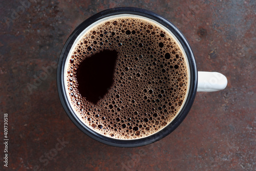 Tableau sur toile Coffee in an enamel mug