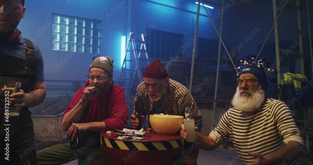 Middle aged man winning bet while watching match with friends Middle aged man winning bet while watching match with friends