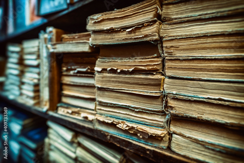 Photos old books on shelves in archive blurred image, library
