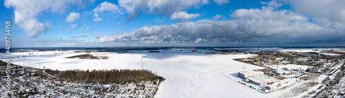 Aerial  panoramic  wide angle winter view of a factory next to a snowy field