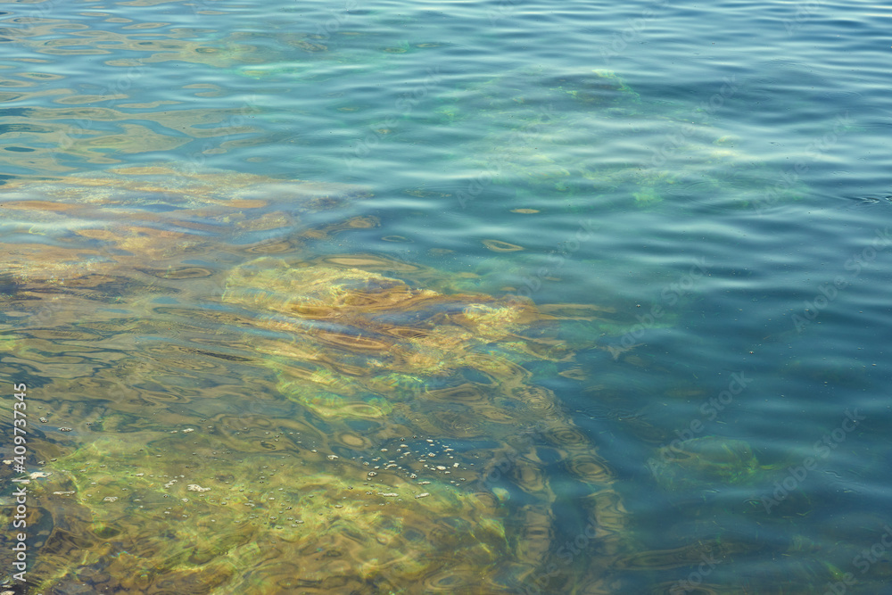 Obraz premium The rocky coast of the mediterranean sea with turquoise water as a natural background.
