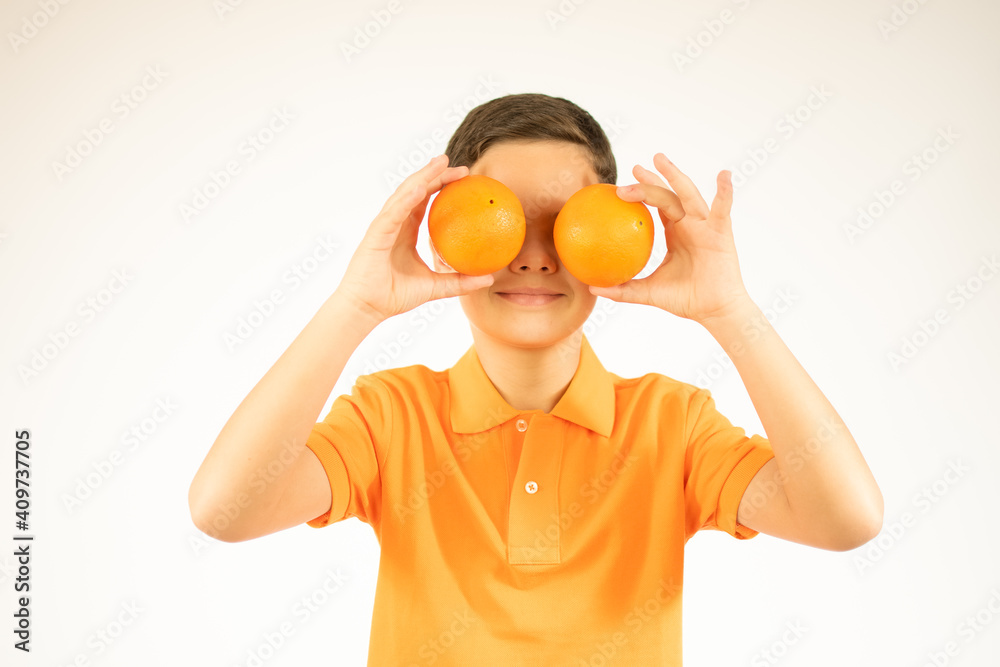Funny boy with fruits on eyes, isolated on white Funny boy with fruits on eyes, isolated on white