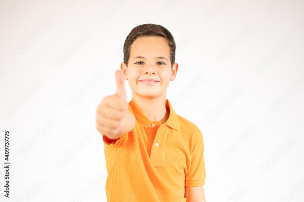 Portrait of a smiling boy showing thumbs up isolated over white background Portrait of a smiling boy showing thumbs up isolated over white background