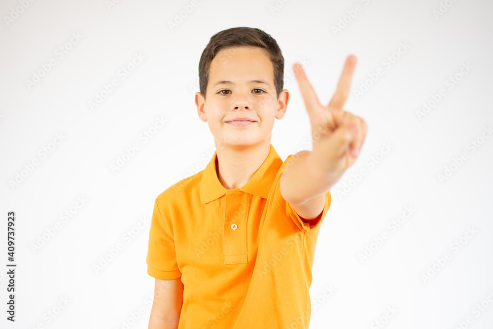 Young little boy victory gesture standing over isolate background Young little boy victory gesture standing over isolate background