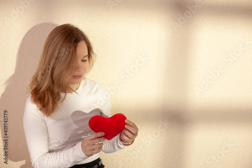 Girl and heart. Background on Valentine's Day. Copy space