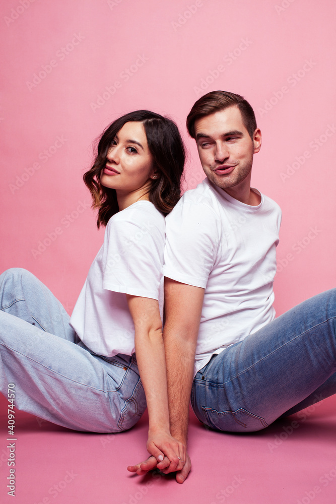 young cheerful caucasian couple together having fun on pink background, guy ang girl modern relationship, lifestyle people concept young cheerful caucasian couple together having fun on pink background, guy ang girl modern relationship, lifestyle people concept
