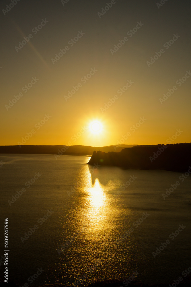 Fototapeta premium Beautiful Three Cliffs Bay at sunset, the Gower Peninsula, Wales. Beach at sunset with hills. 