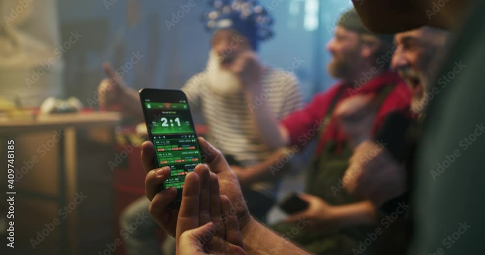 Crop man discussing bet with friends during match