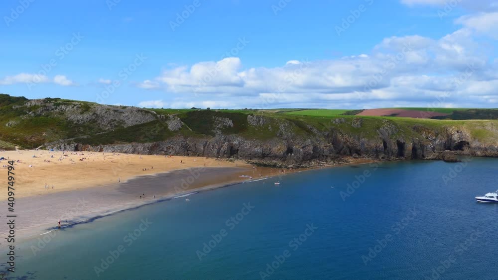 An overlook of a cove with blue ocean and sand beach. An overlook of a cove with blue ocean and sand beach.