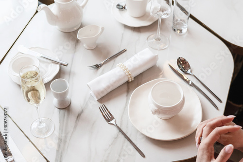 White table setting. Elegant empty plate, cutlery, napkin and cup, for breakfast. Selective Focus