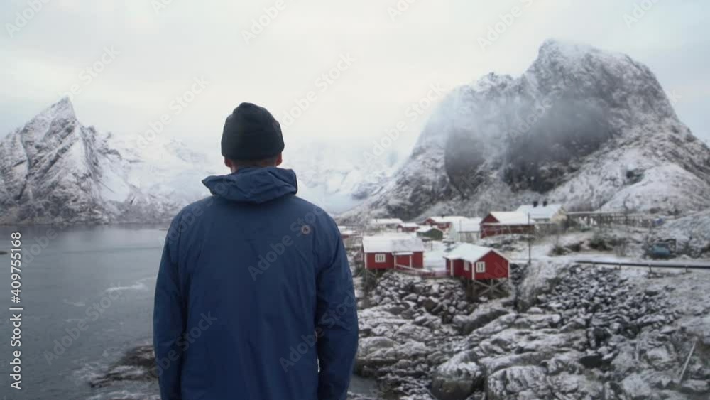 Man By Hamnoy Fishing Village With Olstinden Mountain Man By Hamnoy Fishing Village With Olstinden Mountain