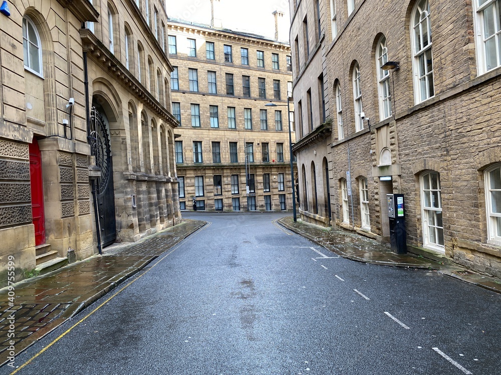 Looking along, Vicar Lane, with Victorian stone built mills, on a wet day in, Little Germany, Bradford, UK