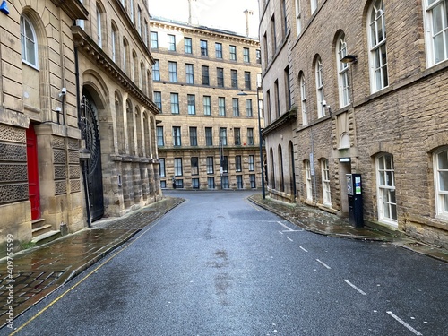 Looking along, Vicar Lane, with Victorian stone built mills, on a wet day in, Little Germany, Bradford, UK