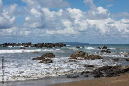 Rocky beach with blue water and blue sky and rocks at Corcovado National Park  Costa Rica.