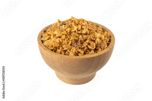 Crispy carmelized fried onion flakes in wooden bowl isolated on white background. Spices and food ingredients.