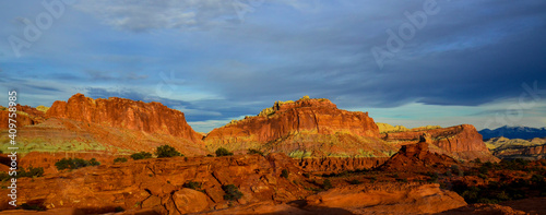 Sunset during golden hour in Southern Utah, sun warming red sandstone, cliffs, mountains, and mesa, and sun © JMP Traveler