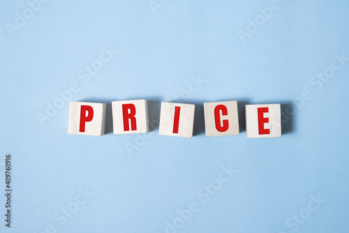 Price word on wooden blocks. Business Concept of falling market value. Promotions and sale. Reduced prices for housing and food. Dumping. Low prices.