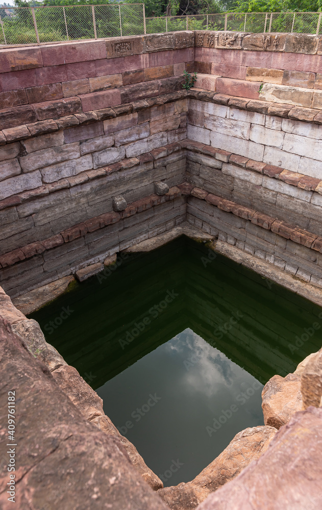 Deep square water hole at Huchchimalli Gudi, Aihole, Karnataka, India