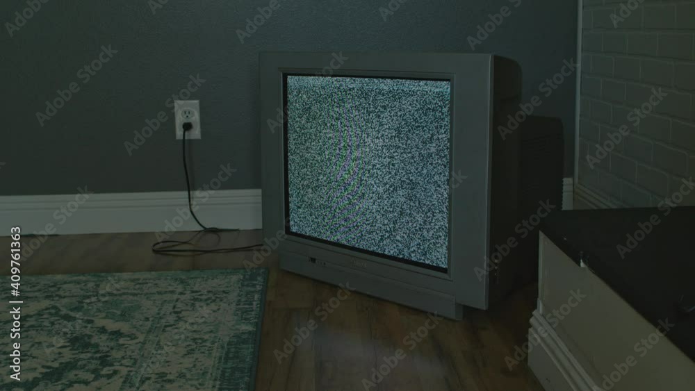 old tube tv in the room with static white noise screen