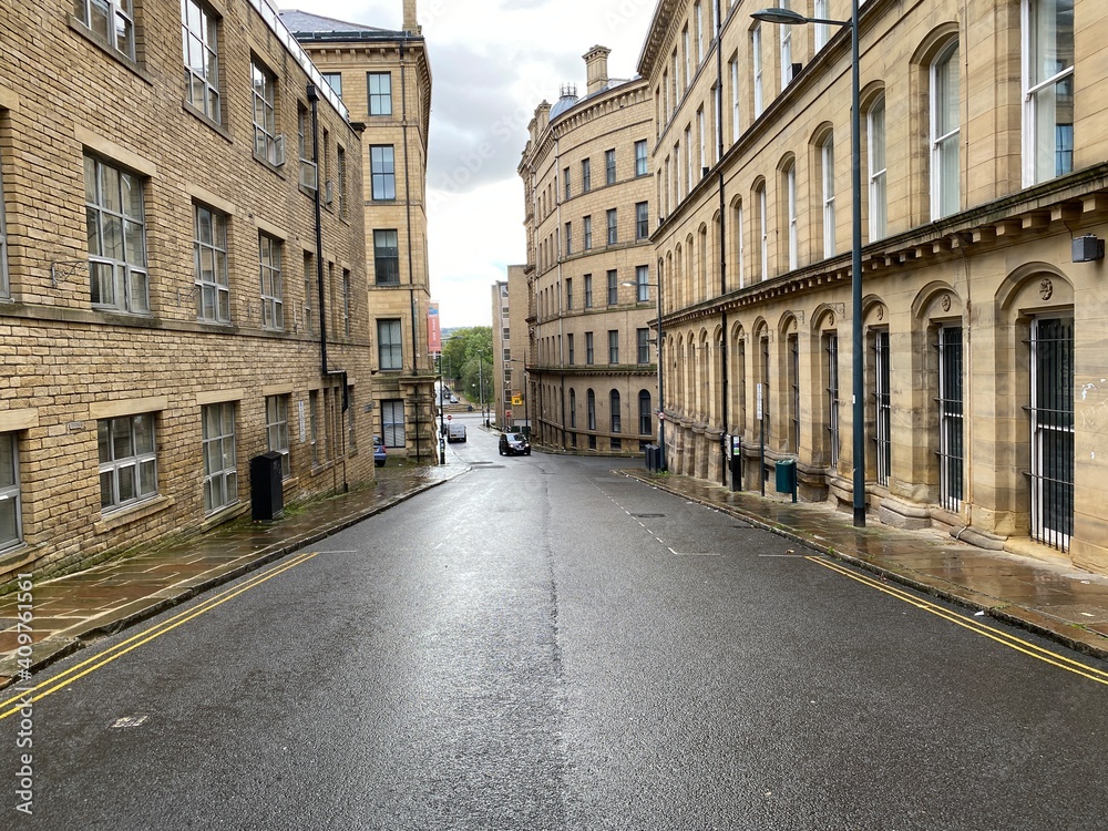 Looking along, Burnett Street, with Victorian stone built textile mills in, Little  Germany, Bradford, UK