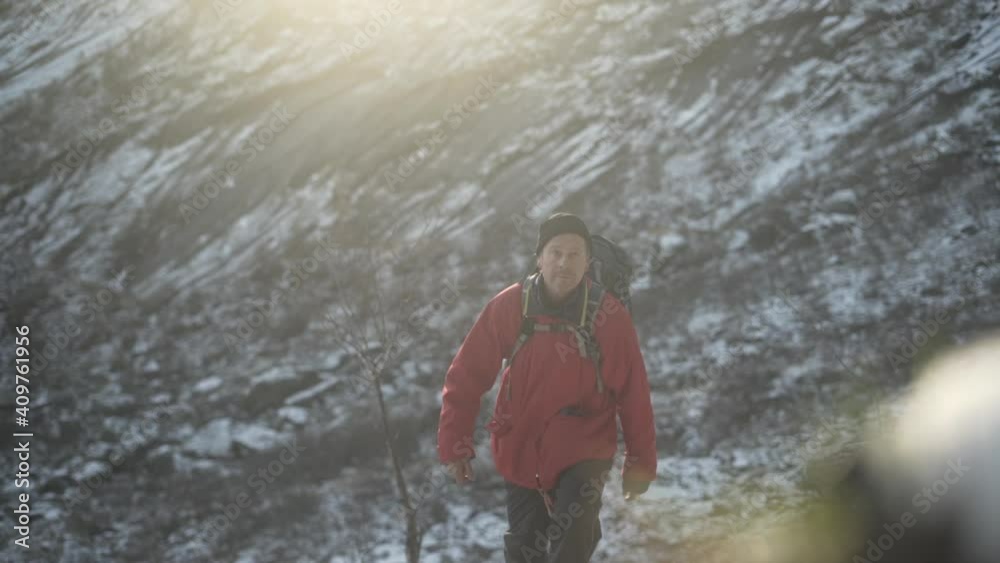 Hiker Walking Up Snowy Mountain Foothill Hiker Walking Up Snowy Mountain Foothill