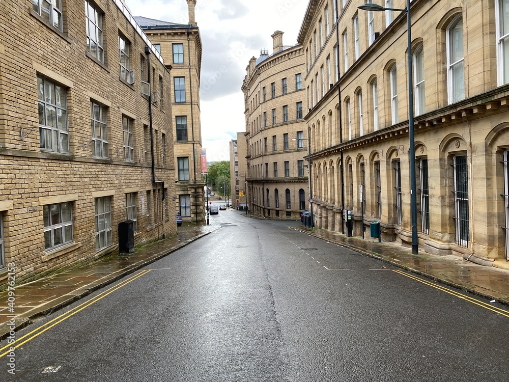 Looking further along, Burnett Street, with Victorian stone built textile mills in, Little  Germany, Bradford, UK