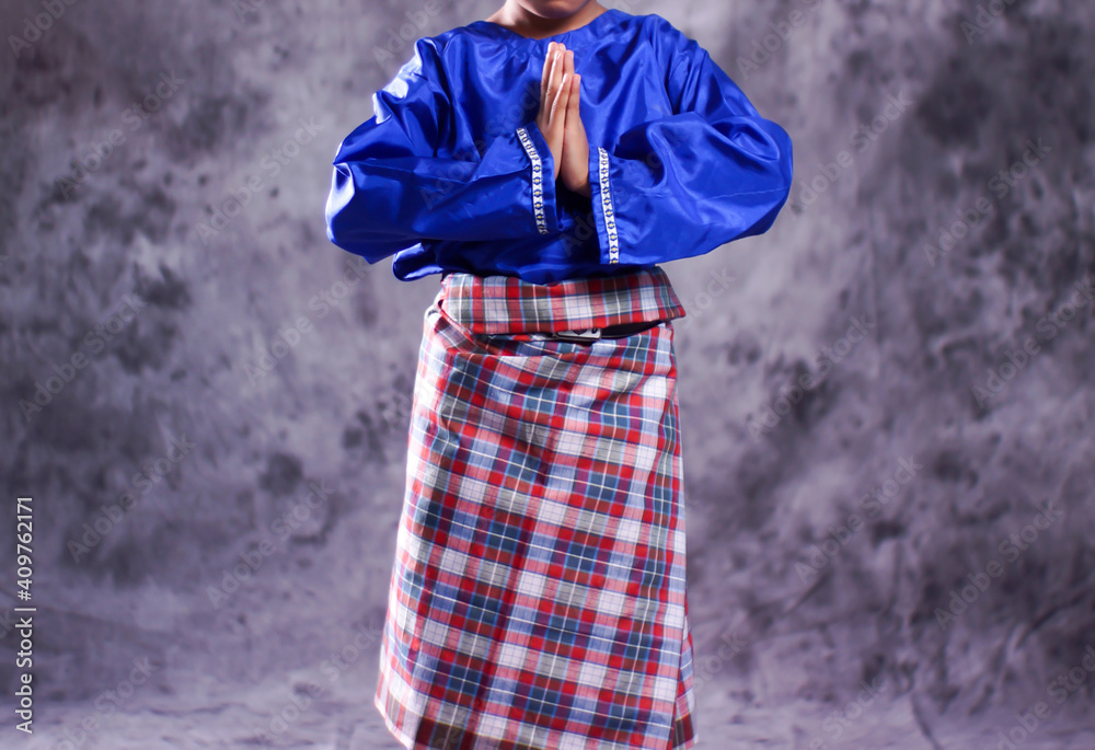 Fototapeta premium Acehnese traditional clothes with sizes for children are used as clothes for Saman dancers. Indonesian traditional clothes with bright colors. Sumatran clothes with a combination of modern styles