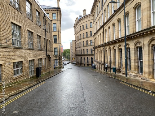 Looking further along, Burnett Street, with Victorian stone built textile mills in, Little Germany, Bradford, UK