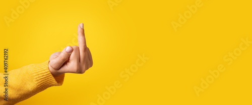 fuck hand sign over yellow background