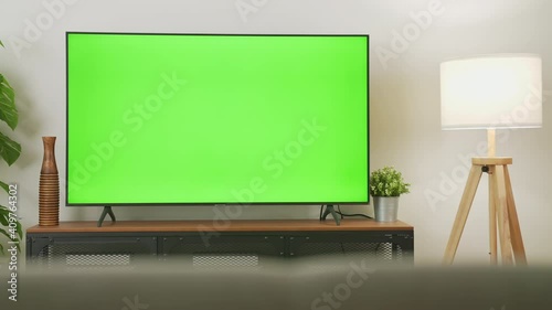 TV Green Screen in living room with tree and lamps. chroma key screen for advertising.