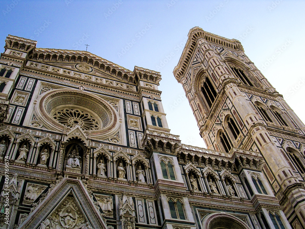Perspective of the Florence cathedral with the marble facade and the tower.