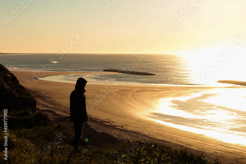 solhouette of person looking at the sea